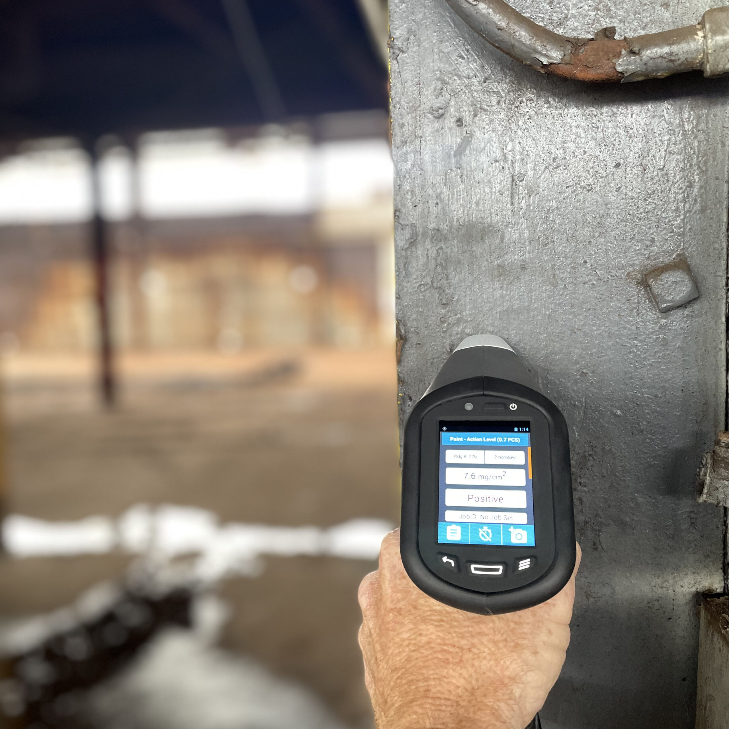 Inspector holding an XRF device for detecting lead based paint